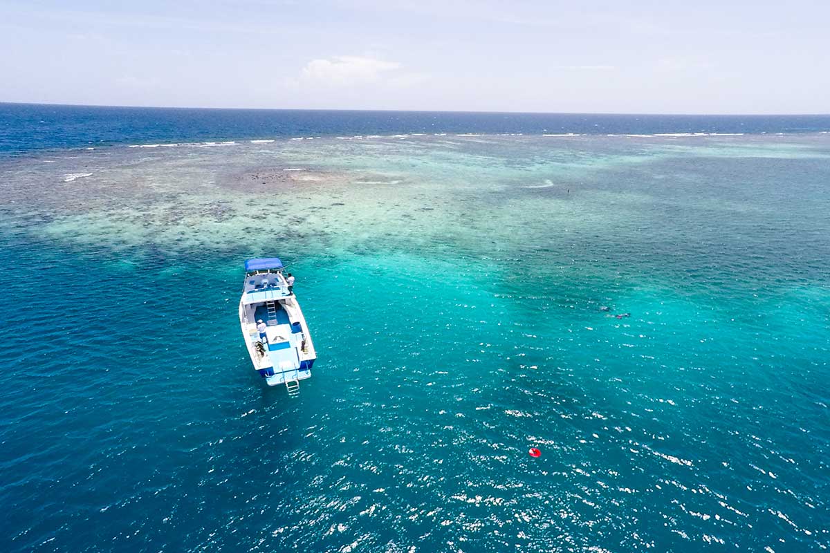 dive boat over shallow reef